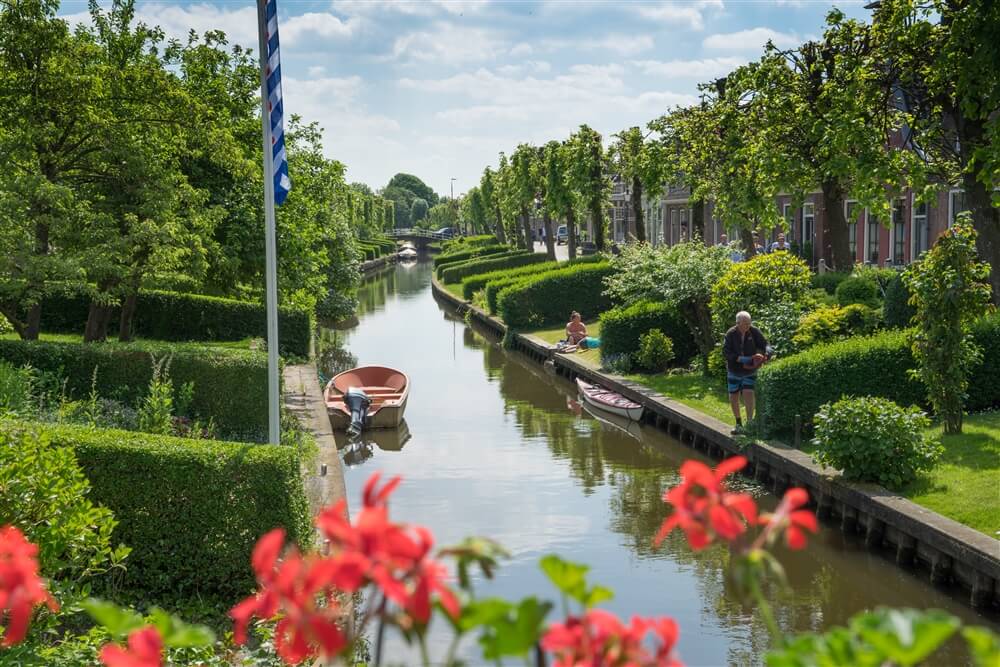 De vaart de Ee door de elf steden stad IJlst met haar bekende overtuinen tijdens een stadswandeling vanaf minicamping de Wetterspetter